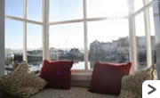 Ellerys Cottage- Sitting room with views of the harbour and beyond.