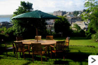 The upper garden has additional seating where the grown-ups can relax and enjoy the view whilst the children run and play on the lawn below.