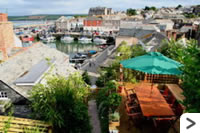 The patio is a short flight of steps from the cottage; ideal for dining out on warm summer days